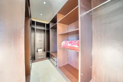 a walk in closet with wooden walls and shelves at Villa Maloulou in Marrakech