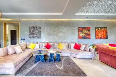 a living room with a couch and a table at Villa Maloulou in Marrakech