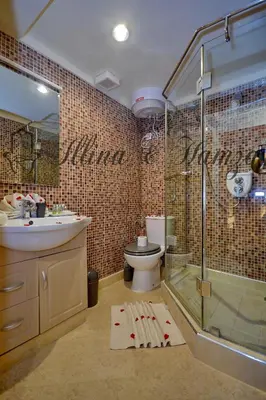 a bathroom with a shower and a toilet and a sink at Illina & Hamza Apartment in Marrakech