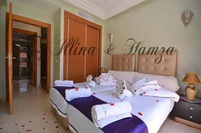 a bedroom with two beds with stuffed animals on them at Illina & Hamza Apartment in Marrakech