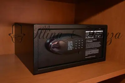 a black microwave oven sitting on a wooden shelf at Illina & Hamza Apartment in Marrakech