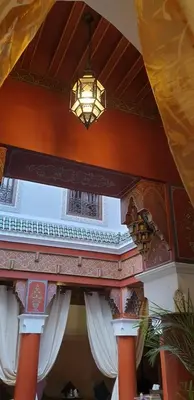 a chandelier hanging from the ceiling of a building at Riad Souad Marrakech in Marrakech