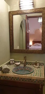 a bathroom with a sink with a mirror over it at Riad Souad Marrakech in Marrakech