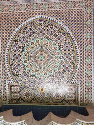 a mosaic tile wall with a design on it at Hotel Salsabil in Marrakech