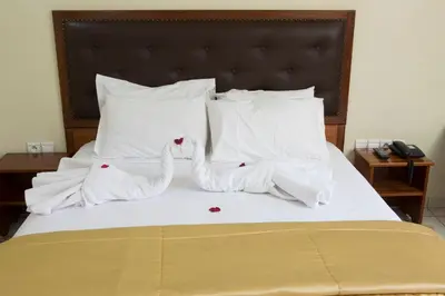 two swans made out of towels on a bed at Hotel Gomassine in Marrakech