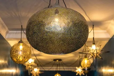 a large ball hanging from a ceiling with chandeliers at Riad Yamina52 in Marrakech