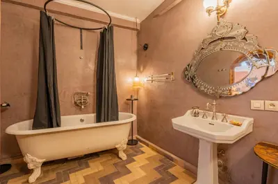 a bathroom with a tub and a sink and a mirror at Riad Yamina52 in Marrakech