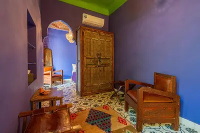a room with an old wooden door and a chair at Riad Yamina52 in Marrakech