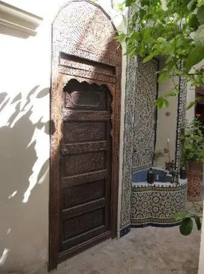 a door to a bathroom with a sink at Nadir Home in Marrakech
