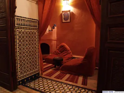 a room with two chairs and a fireplace at Nadir Home in Marrakech