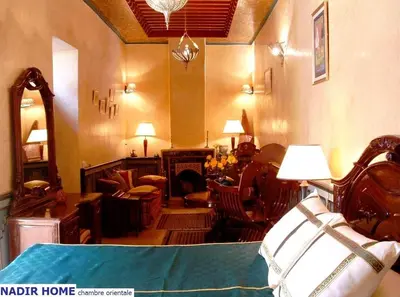 a living room filled with furniture and a fireplace at Nadir Home in Marrakech