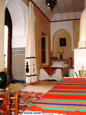 a bedroom with a bed and a rug in a room at Nadir Home in Marrakech