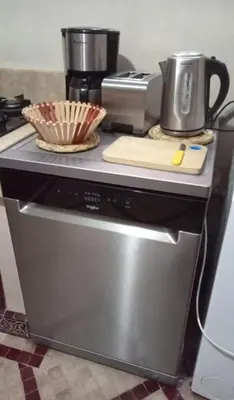 a kitchen counter with a coffee maker on top of a stove at Charmant Riad avec piscine, au Coeur de Marrakech in Marrakech