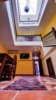 a room with a rug on the floor and a ceiling at Riad Prestigia in Marrakech
