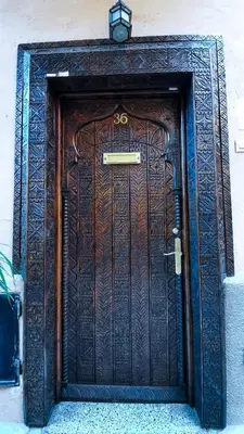 a wooden door with a sign on top of it at Riad Prestigia in Marrakech