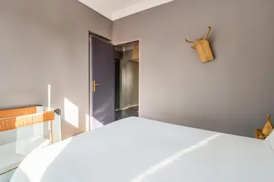 a bedroom with a white bed and a window at Villa Lila in Marrakech