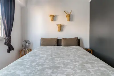 a bedroom with a bed and two crosses on the wall at Villa Lila in Marrakech
