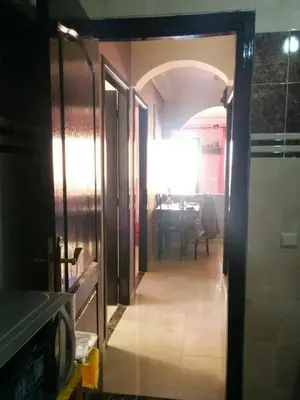 a hallway leading to a dining room with a table at Superbe appartement avec terrasse in Marrakech