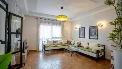 a living room with a couch and a table at Appartement aux portes de la palmeraie in Marrakech