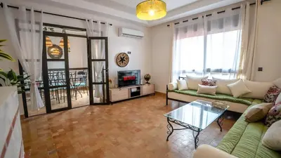 a living room with a couch and a table at Appartement aux portes de la palmeraie in Marrakech
