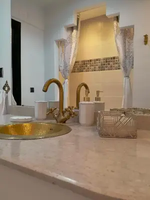 a bathroom counter with two sinks and two faucets at Appartement aux portes de la palmeraie in Marrakech