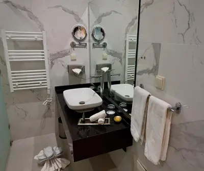 a bathroom with a sink and a mirror at Sillage Palace Sky & Spa in Marrakech