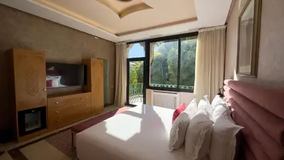 a bedroom with a bed and a large window at Sillage Palace Sky & Spa in Marrakech