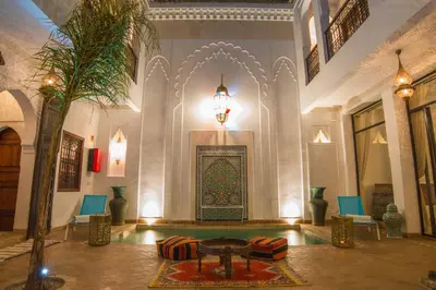 a lobby with a table and a fireplace in a building at Riad la clé d'or & spa in Marrakech