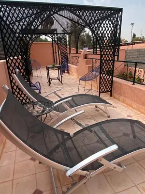 a group of chairs sitting on a patio at Dar Sarah-Mouassine-Marrakech, Riad authentique idéalement situé in Marrakech