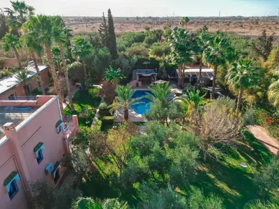 an aerial view of a resort with a pool and palm trees at RIAD REDWAN in Marrakech
