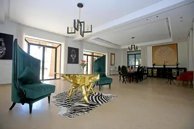 a living room with a table and chairs at Domaine DAR JMEL & Dar Abi Samama in Marrakech