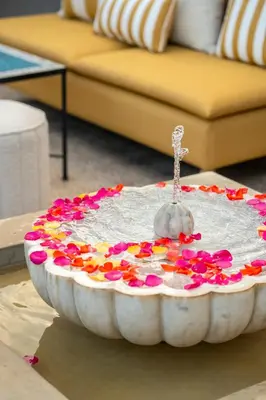 a cake with flowers on a table in a living room at Riad Les Yeux Bleus in Marrakech
