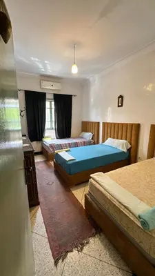 a room with three beds in a room at Dar el Koutoubia in Marrakech