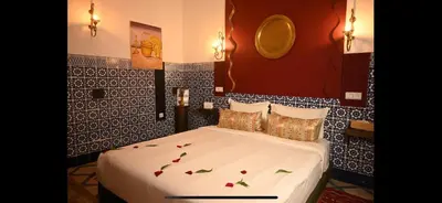 a bedroom with a bed with flowers on it at Riad Nouceiba Marrakech in Marrakech