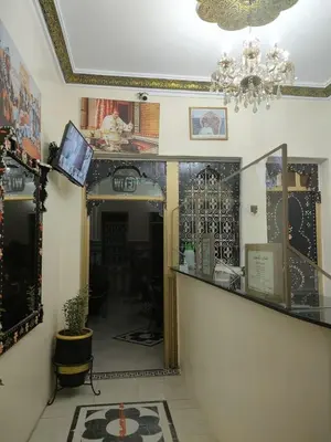 a room with a hallway with a mirror and a chandelier at Hotel Zagora in Marrakech