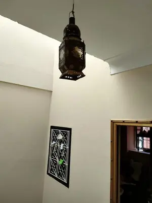 a clock hanging on a wall with a window at Hotel Zagora in Marrakech