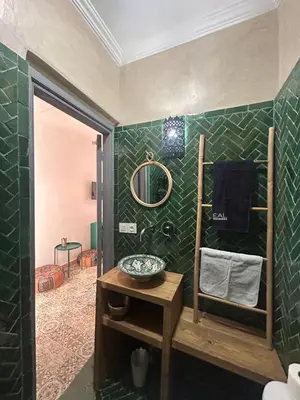 a bathroom with a sink and a mirror at RIAD TIFAWT in Marrakech