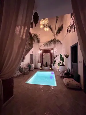 a large room with a swimming pool in a house at RIAD TIFAWT in Marrakech
