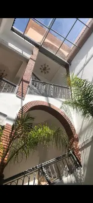 a building with a staircase with plants in it at RIAD TIFAWT in Marrakech