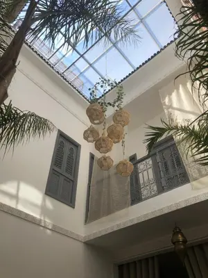 a glass ceiling with a chandelier in a house at RIAD TIFAWT in Marrakech