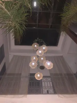 a chandelier is hanging in front of a window at RIAD TIFAWT in Marrakech