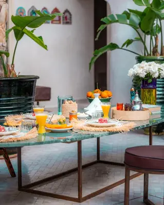 a table with food and drinks on top of it at Riad La Lumière d'Étoile in Marrakech
