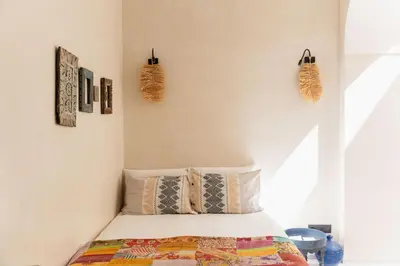 a bedroom with a bed and some baskets on the wall at Riad La Lumière d'Étoile in Marrakech
