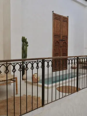 a balcony with a gate and a wooden door at Riad La Lumière d'Étoile in Marrakech