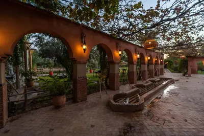 a row of benches in a building with lights at Domaine Alma Marrakech in Marrakech
