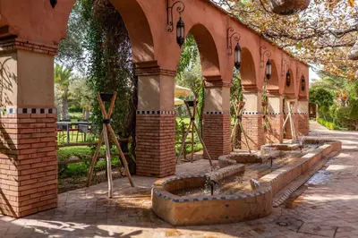 a row of water fountains in a building at Domaine Alma Marrakech in Marrakech