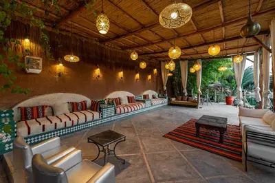 a living room with couches and tables and lights at Domaine Alma Marrakech in Marrakech