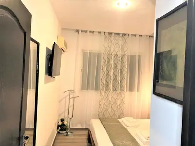 a small white room with a bed and a window at SUPER APPART Marrakech - Confort Propreté Proximité in Marrakech
