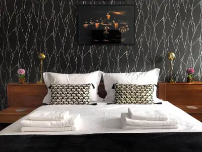 a bedroom with a large bed with white sheets and pillows at SUPER APPART Marrakech - Confort Propreté Proximité in Marrakech