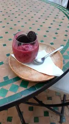 a bowl of food on a table with a spoon at Riad Amegrad in Marrakech